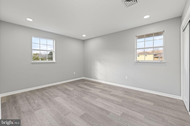 unfurnished room with light hardwood / wood-style flooring