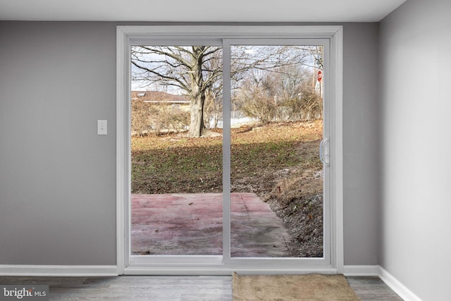 doorway to outside with hardwood / wood-style floors and a healthy amount of sunlight