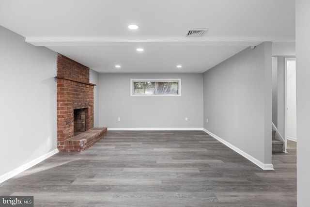 unfurnished living room with hardwood / wood-style flooring and a fireplace