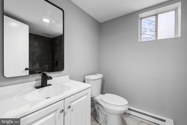 bathroom featuring vanity, toilet, and a baseboard heating unit