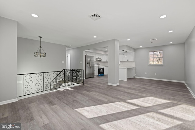 unfurnished living room with light hardwood / wood-style floors