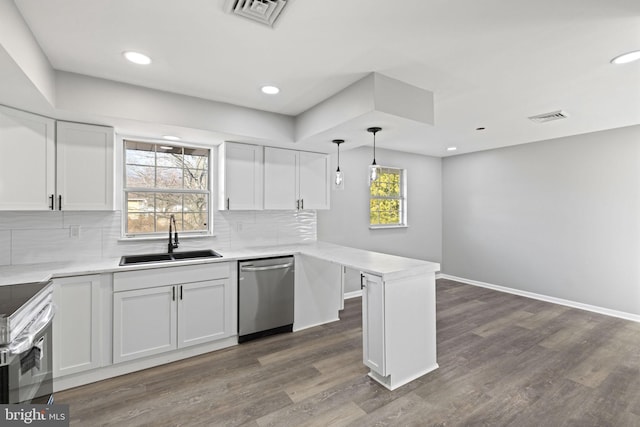 kitchen with plenty of natural light, white cabinets, and appliances with stainless steel finishes