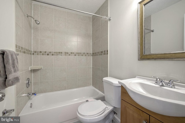 full bathroom with toilet, vanity, and tiled shower / bath combo