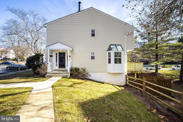 rear view of property with a lawn