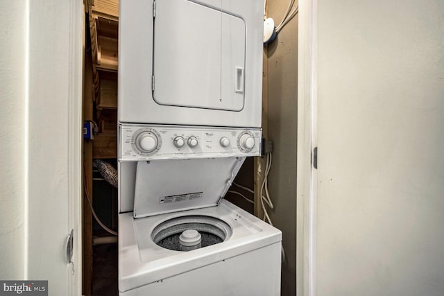 clothes washing area featuring stacked washer and dryer