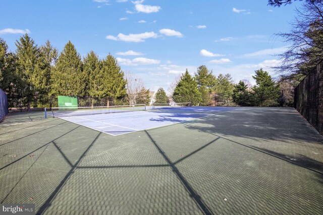 view of tennis court with basketball hoop