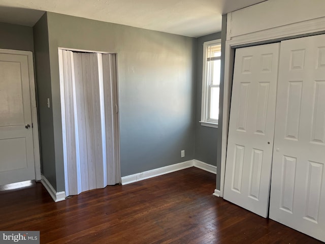 unfurnished bedroom with dark hardwood / wood-style floors