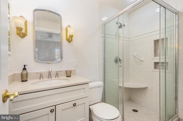 bathroom featuring vanity, toilet, and walk in shower