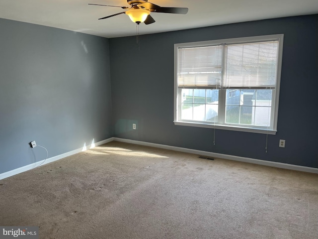 spare room featuring ceiling fan and carpet floors