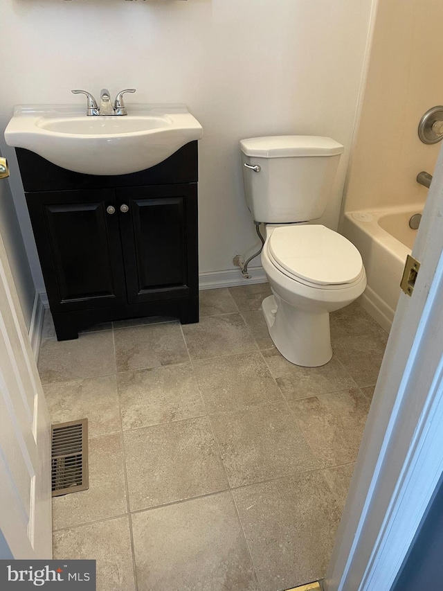 bathroom with tile patterned floors, vanity, and toilet