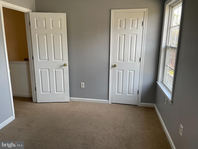 unfurnished bedroom featuring light colored carpet