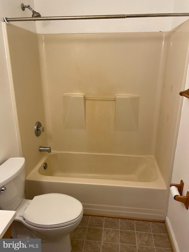 full bathroom with tile patterned floors, vanity, washtub / shower combination, and toilet