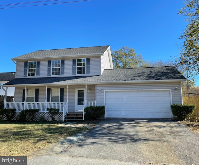 view of front of property featuring covered porch and a garage