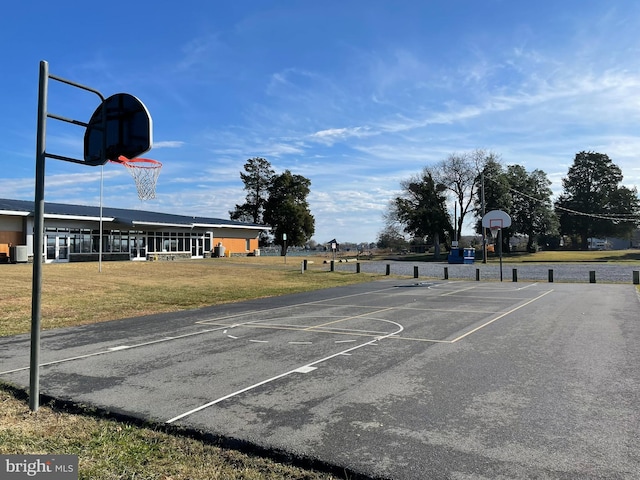 view of basketball court with a yard