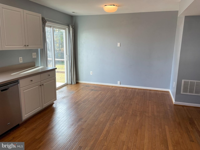 kitchen featuring stainless steel dishwasher, light hardwood / wood-style floors, and white cabinetry