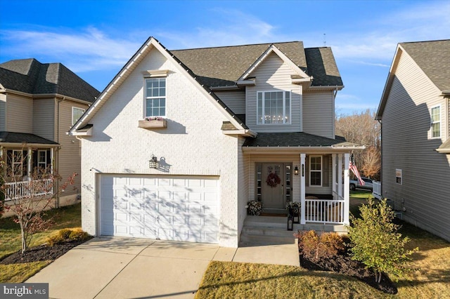 front of property featuring covered porch and a garage