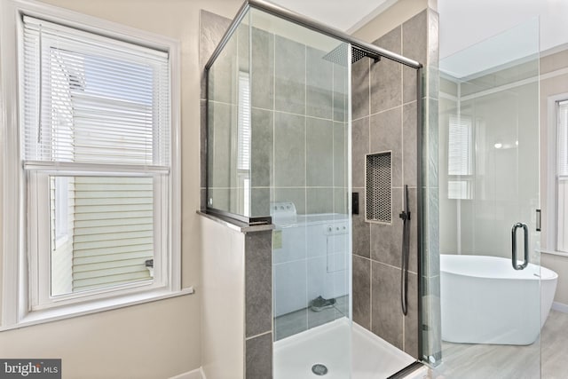 bathroom featuring shower with separate bathtub