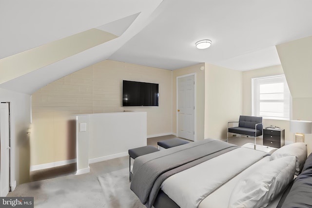 bedroom featuring light colored carpet and lofted ceiling