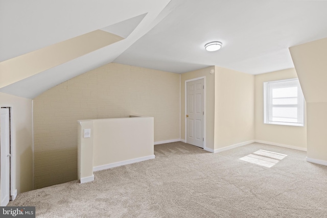 additional living space with light colored carpet and lofted ceiling