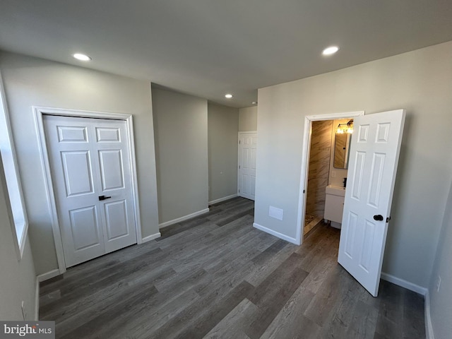 unfurnished bedroom featuring dark hardwood / wood-style floors and a closet