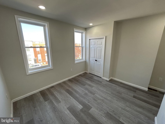 unfurnished room featuring dark hardwood / wood-style floors