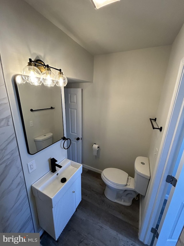 bathroom with vanity, hardwood / wood-style flooring, and toilet