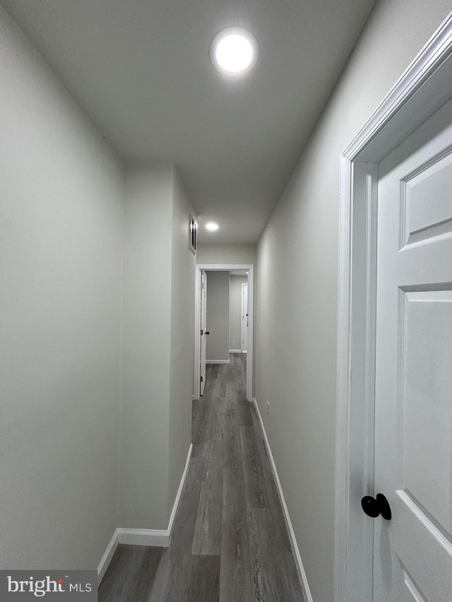 hallway with dark wood-type flooring