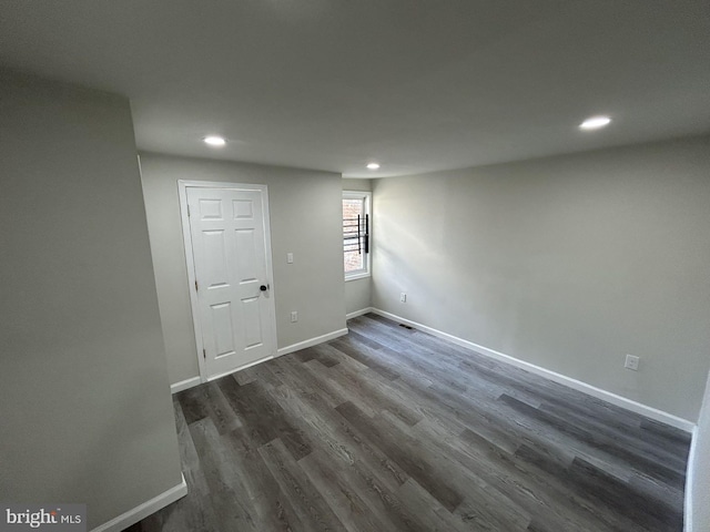 basement featuring dark hardwood / wood-style flooring