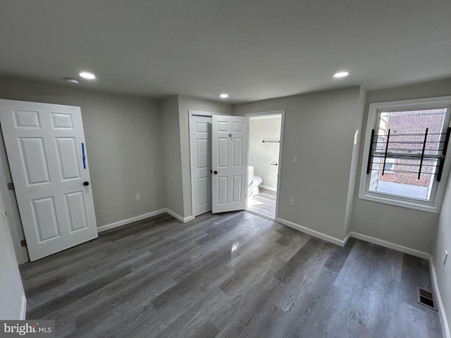 unfurnished room with dark wood-type flooring