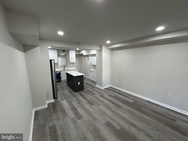 kitchen featuring a center island, white cabinetry, and dark wood-type flooring