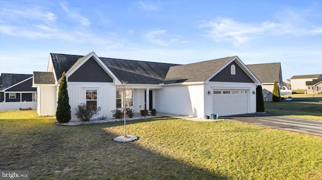 ranch-style house with a garage and a front lawn