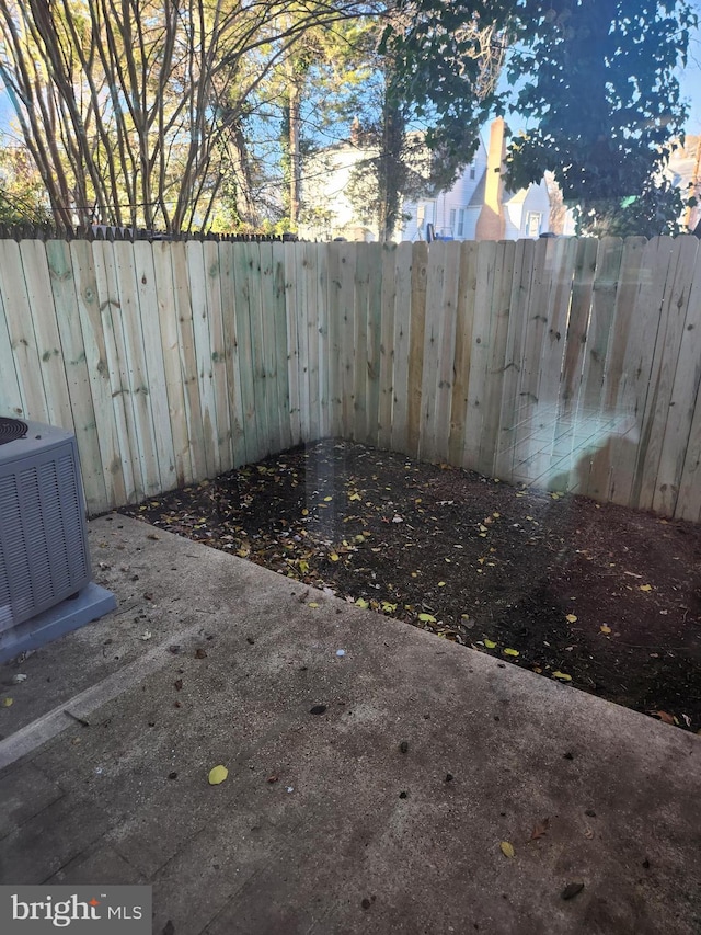 view of yard featuring a patio area and central AC