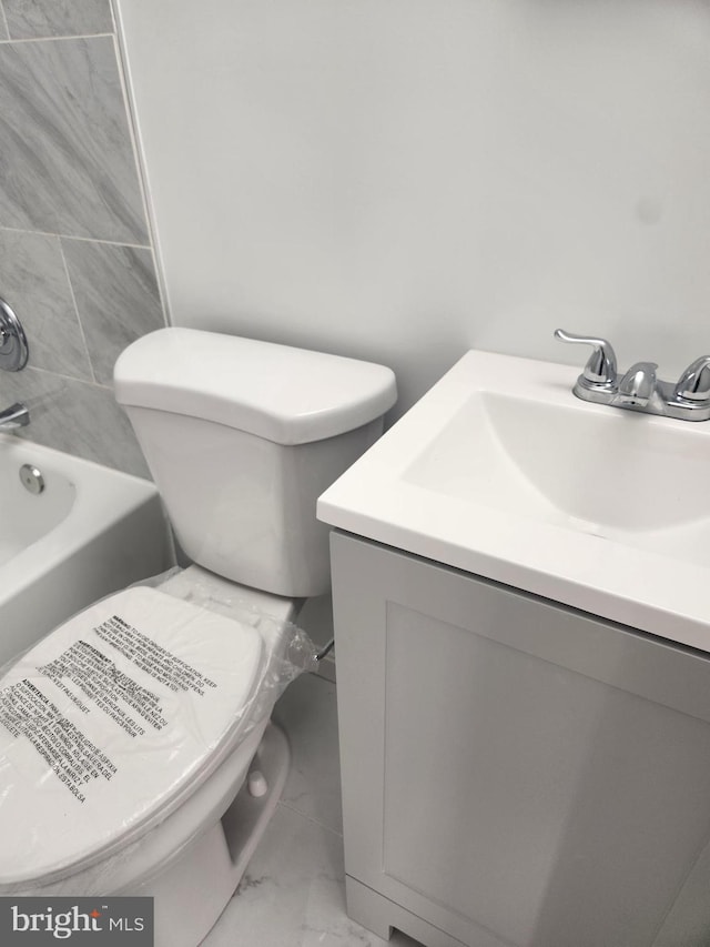 full bathroom with vanity, toilet, and tiled shower / bath