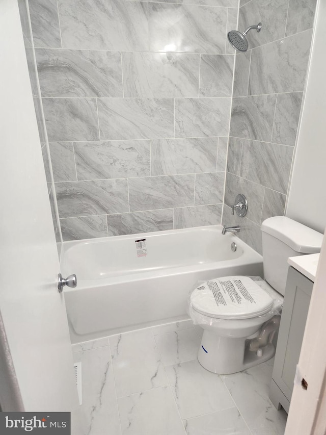 full bathroom with toilet, vanity, and tiled shower / bath combo