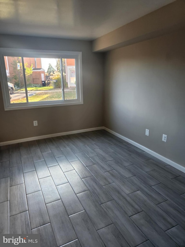 empty room with wood-type flooring