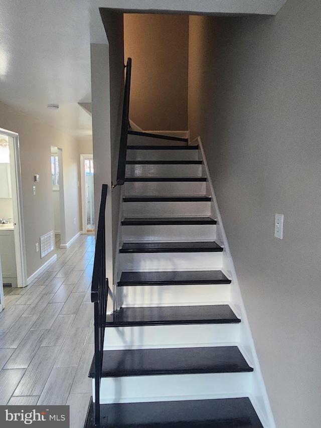 staircase featuring hardwood / wood-style flooring