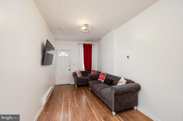 living room with wood-type flooring and a baseboard radiator