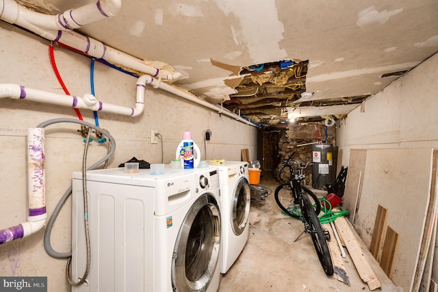 laundry room with washing machine and dryer and water heater