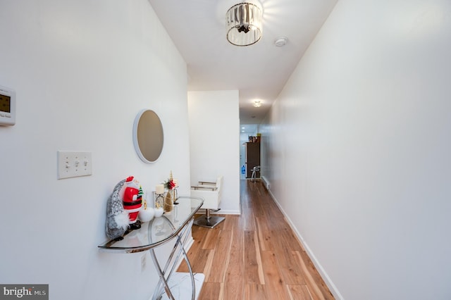 hallway with hardwood / wood-style flooring