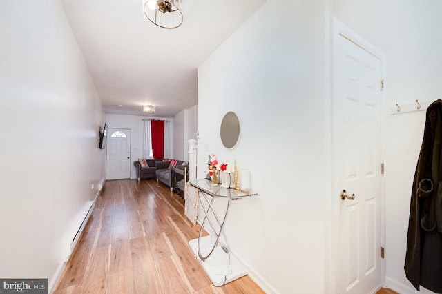 hall with light wood-type flooring and baseboard heating