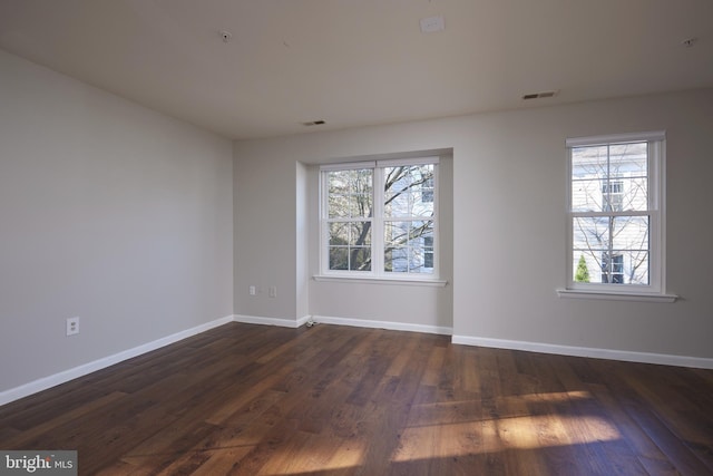 empty room featuring dark hardwood / wood-style floors