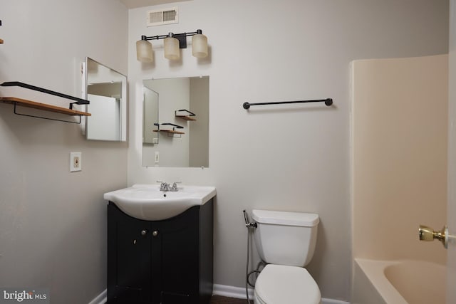 bathroom featuring vanity and toilet