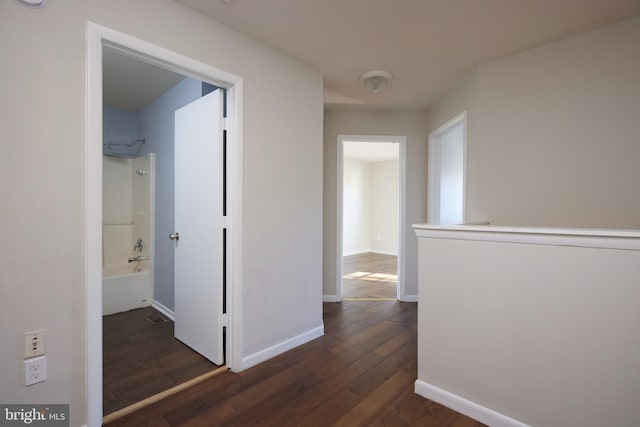 hall with dark wood-type flooring