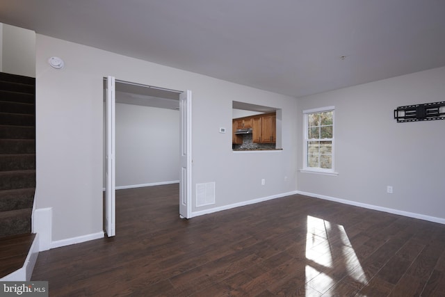 unfurnished living room with dark hardwood / wood-style flooring