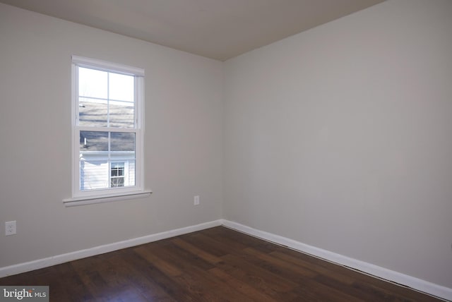 empty room with dark wood-type flooring