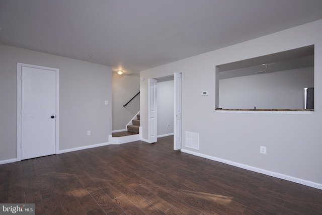 empty room featuring dark hardwood / wood-style flooring