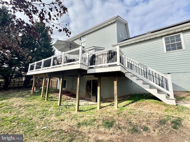 back of property with a yard and a deck