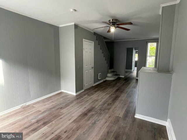 interior space with ceiling fan, crown molding, and dark hardwood / wood-style floors