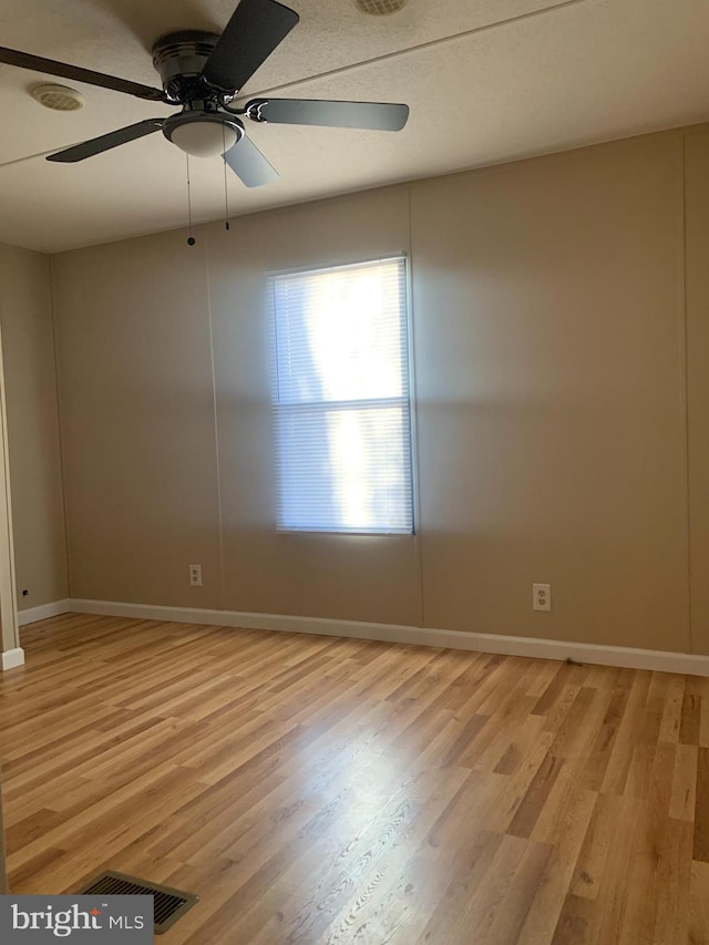 unfurnished room with light hardwood / wood-style flooring and ceiling fan