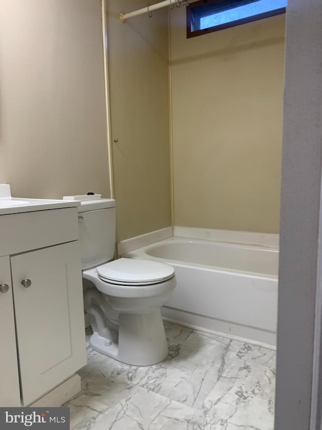 bathroom featuring a bathtub, vanity, and toilet